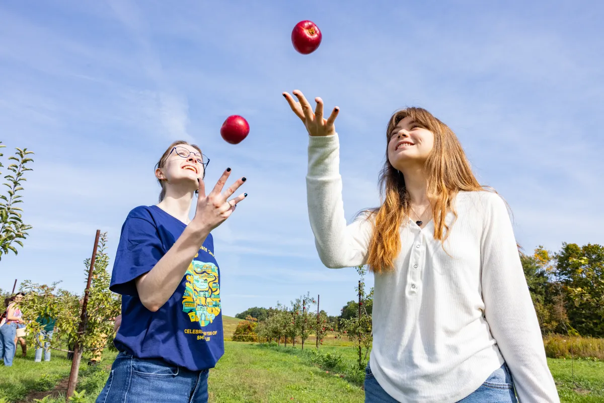 Students throw apples in the air on Mountain Day 2025