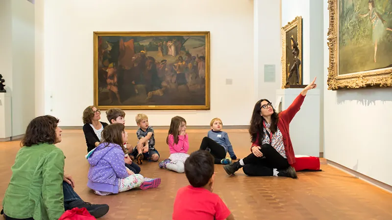 Smith student leading a class with young children in the Smith College Art Museum