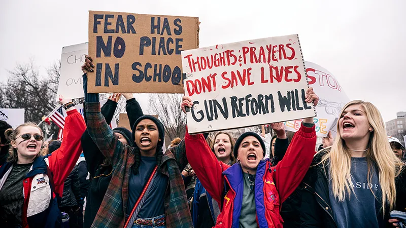 Students holding signs protesting gun violence in schools