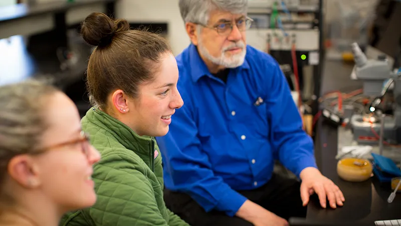 Abby Bergman in a science lab with a professor