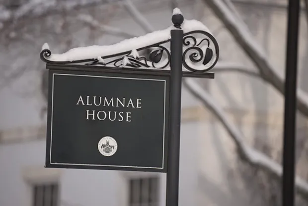 The sign for the Alumnae House, covered in snow.