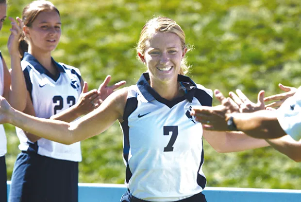 Smith athlete walks among teammates who congratulate her